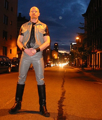 Picture of John in a leather vest at The Hoist, smiling at the camera